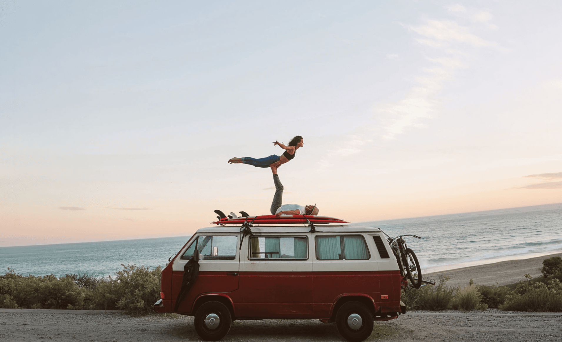Person standing on a van by the California coast